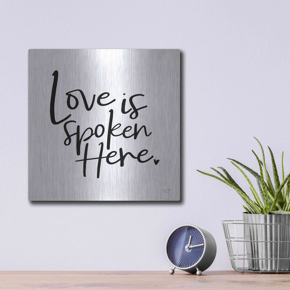 'Love is Spoken Here' by Lux + Me – Metal Wall Art, 12x12 room view